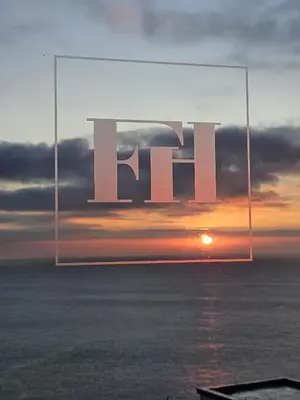 a sunset with the word el in a picture of the ocean at Fieldhead Hotel, Looe in Looe