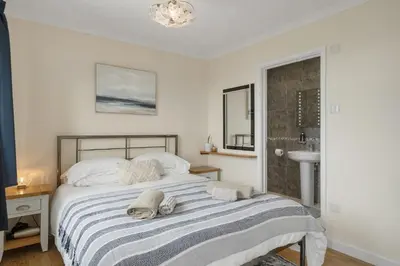 a bedroom with a bed with towels on it at Peaceful Home Sea Views Private Parking in Treknow
