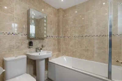 a bathroom with a tub and a toilet and a sink at Peaceful Home Sea Views Private Parking in Treknow