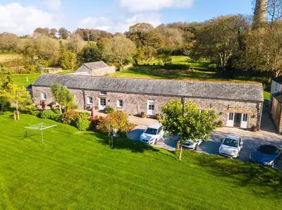 an aerial view of a stone house with parked cars at Starfish Cottage in Charlestown