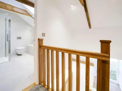 a staircase in a house with a toilet at Starfish Cottage in Charlestown