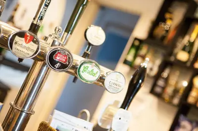 a bunch of push buttons on a bar at The Old School Hotel in Port Isaac
