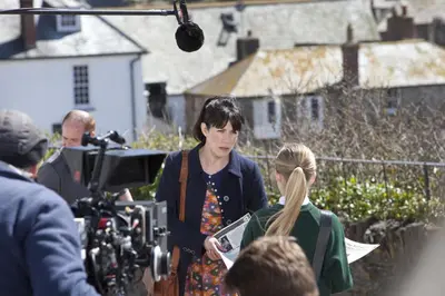 a woman standing in front of a crowd of people at The Old School Hotel in Port Isaac