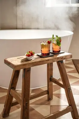 a wooden table with two bowls of vegetables on it at Topsy Turvy and Hillside Spa at Tregoose Old Mill in Newquay