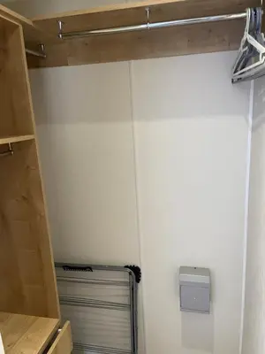 a room with a closet with a radiator and a shelf at Rubys Retreat - 6 Berth Caravan in Newquay, Cornwall in Newquay