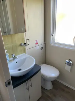 a bathroom with a sink and a toilet at Rubys Retreat - 6 Berth Caravan in Newquay, Cornwall in Newquay