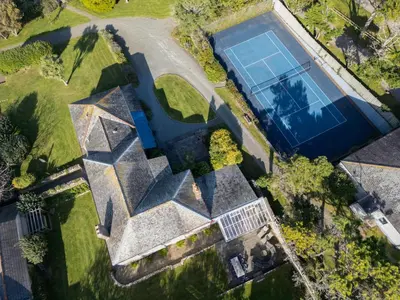 an overhead view of a tennis court and a pool at Trevornick Farm House in Newquay