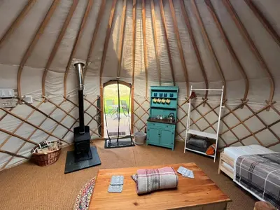 an interior of a yurt with a table and a stove at Yurt in Hayle