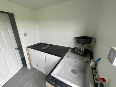 a small kitchen with a counter and a sink at Yurt in Hayle