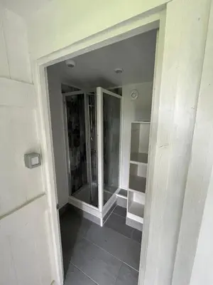a bathroom with a glass shower in a room at Yurt in Hayle
