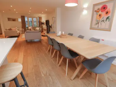 a dining room with a wooden table and chairs at Una, Lodge 73 in St Ives