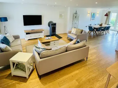 a living room with two couches and a flat screen tv at Una, Lodge 73 in St Ives