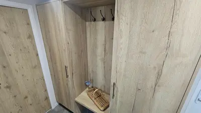 a shower with wooden doors in a bathroom at Hot Tub Lodge Cornwall in St Austell