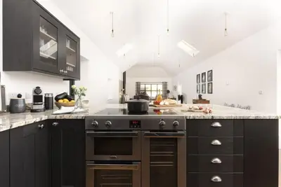 a kitchen with a stove and a counter top at Trebyre in Padstow