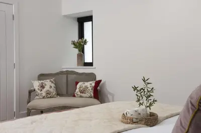 a living room with a chair and a table at Trebyre in Padstow