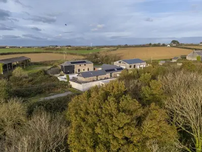 an aerial view of a farm with houses and trees at Trebyre in Padstow