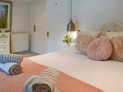 a bedroom with a large bed with pillows on it at Crew Quarters in Fowey