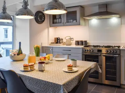 a kitchen with a table with food on it at Crew Quarters in Fowey