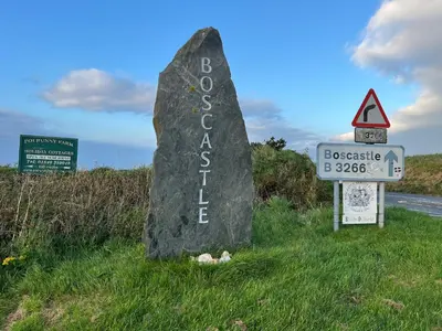 a rock sign on the side of a road at Rosebank Cottage in Boscastle