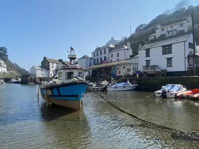 a boat is docked in a body of water at The Artists Studio in Saint Cleer