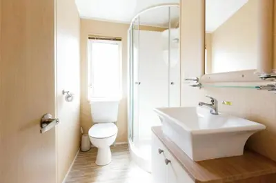 a bathroom with a white toilet and a sink at Cousins beach house Three bedroom lodge St Minver in Wadebridge