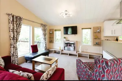 a living room with a couch and a table at Cousins beach house Three bedroom lodge St Minver in Wadebridge