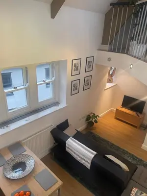 a living room with a couch and a table at The Loft St Austell in St Austell
