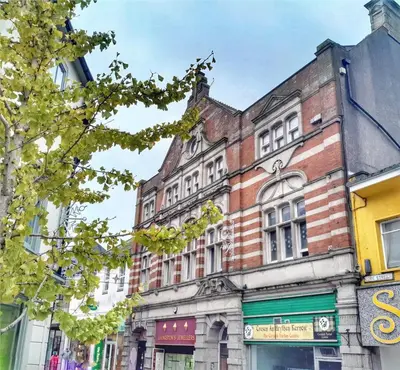 an old brick building on a city street at The Loft St Austell in St Austell