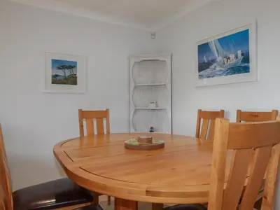 a wooden table and chairs in a room at 3 The Bowling Green in Truro