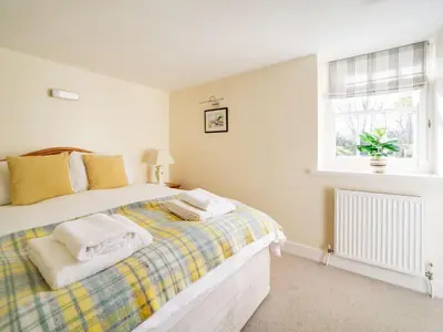 a bedroom with a bed with towels on it at Dolphin Cottage in Charlestown