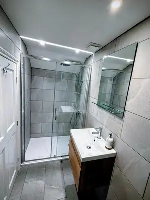 a bathroom with a shower and a sink at Dolphin Cottage in Charlestown