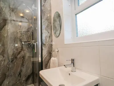 a bathroom with a sink and a shower at Sea Dream in Falmouth