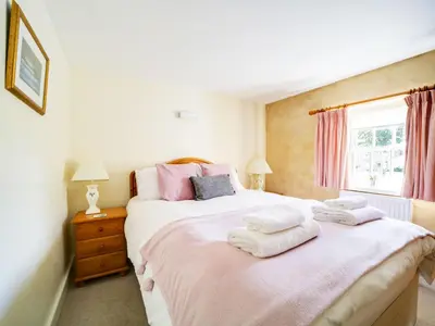 a bedroom with two beds with towels on them at Turtle Cottage in Charlestown