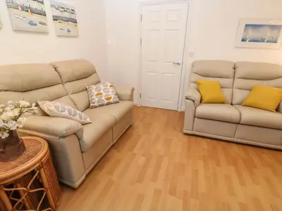 a living room with two couches and a table at Sea View in St Ives