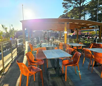 an outdoor patio with tables and chairs and aented at JL Cornwall Newquay Caravan in Newquay