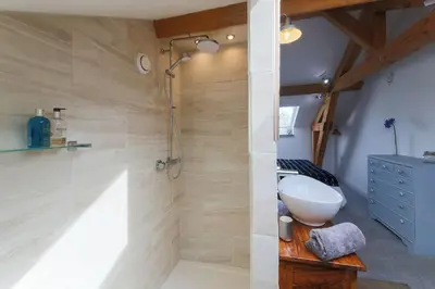 a bathroom with a walk in shower and a sink at Little Bream - pretty cosy cottage, sea views, walk to the beach in Mawnan Smith