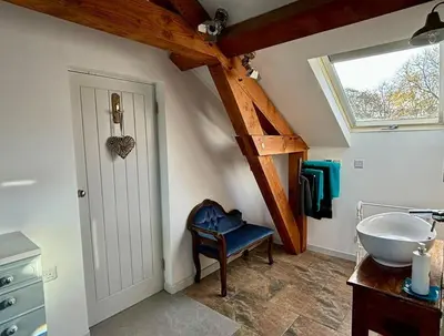 a bathroom with a sink and a window at Little Bream - pretty cosy cottage, sea views, walk to the beach in Mawnan Smith