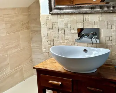a white sink on a wooden counter in a bathroom at Little Bream - pretty cosy cottage, sea views, walk to the beach in Mawnan Smith