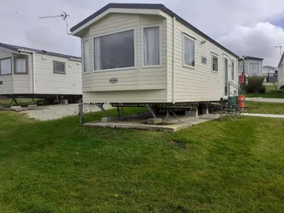 a mobile home is parked in a yard at PerranporthCaravan 2bedroom Tv GasFire in Perranporth