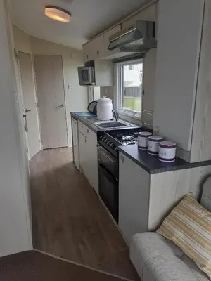 a kitchen with a stove and a counter top at PerranporthCaravan 2bedroom Tv GasFire in Perranporth