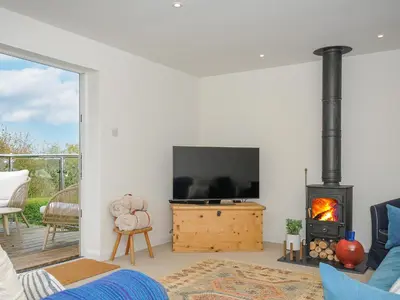 a living room with a tv and a fireplace at Seamay in Wadebridge