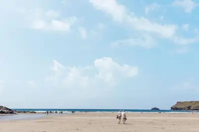 two people walking on the beach at Seamay in Wadebridge