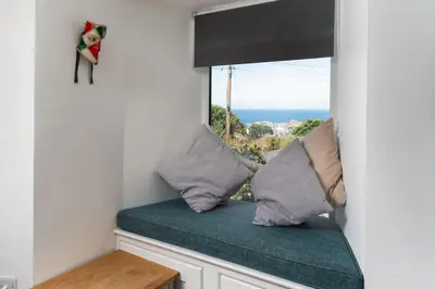 a window seat with a view of the ocean at Gwel Porth - St Ives - Sea Views in St Ives