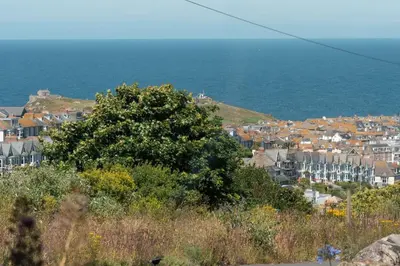 a view of a town with houses and the ocean at Gwel Porth - St Ives - Sea Views in St Ives