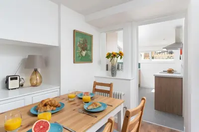 a kitchen and dining room with a table with food on it at Gwel Porth - St Ives - Sea Views in St Ives