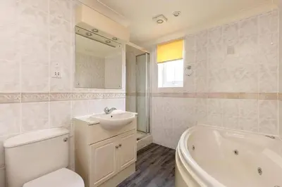 a bathroom with a toilet and a sink and a tub at Newquay - Atlantic Lodge - 10 - Pets - Pools - Gym in Newquay