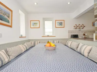 a room with a table with a bowl of fruit on it at Seaworthy in Wadebridge