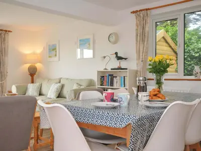 a living room with a table and a couch at Seaworthy in Wadebridge
