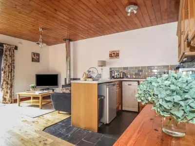 a kitchen and living room with a counter top at Court Cottage in Looe