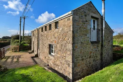 an old stone building with a window on the side at Finest Retreats - Trennal Barn in Germoe